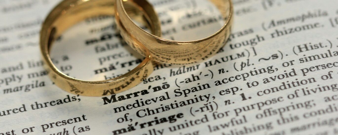 two gold-colored rings on paper