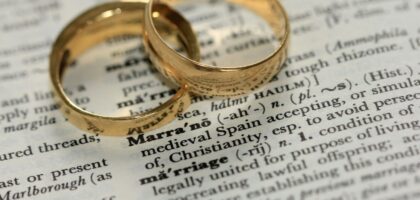 two gold-colored rings on paper