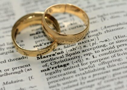 two gold-colored rings on paper